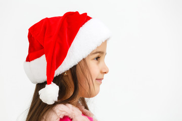 Wall Mural - Portrait of pretty christmas girl in santa hat, smiling isolated on white background