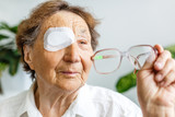 Fototapeta  - Elderly use eye shield covering after cataract surgery.