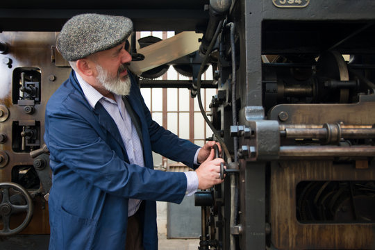 Mechanic working on a vintage printing press