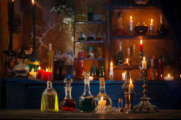 Wall Mural - magic potions in bottles on wooden background