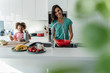 © Westend61 - Happy mother and daughter cooking in kitchen together