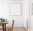 © Jodie Johnson/Austockphoto - Blank framed print on white wall in beautiful Danish styled interior dining room
