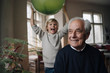 © Westend61 - Portrait of smiling senior man with grandson holding balloon in background