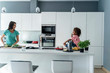 © Westend61 - Happy mother and daughter cooking in kitchen together