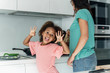 © Westend61 - Portrait of happy girl cooking with mother in kitchen
