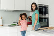 © Westend61 - Happy mother and daughter cooking in kitchen together
