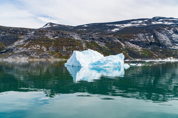 Wall Mural - Photo of Iceberg and ice from glacier in arctic nature landscape on Greenland. Icebergs in Ilulissat icefjord. Affected by climate change and global warming.