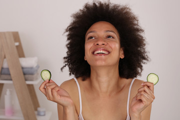 Wall Mural - Woman use cucumber slices to treat dark circles , fresh clean skin. Home Skin care treatments, Natural Beauty