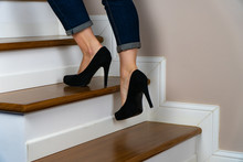 Girl With Heels And Jeand On The Stairs Going Up