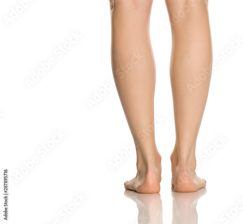 Photographie Beautifully groomed female legs on a white background
