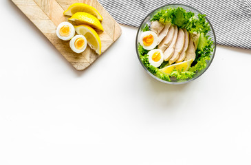 Wall Mural - Salad bowl with healthy food on white background top view copyspace