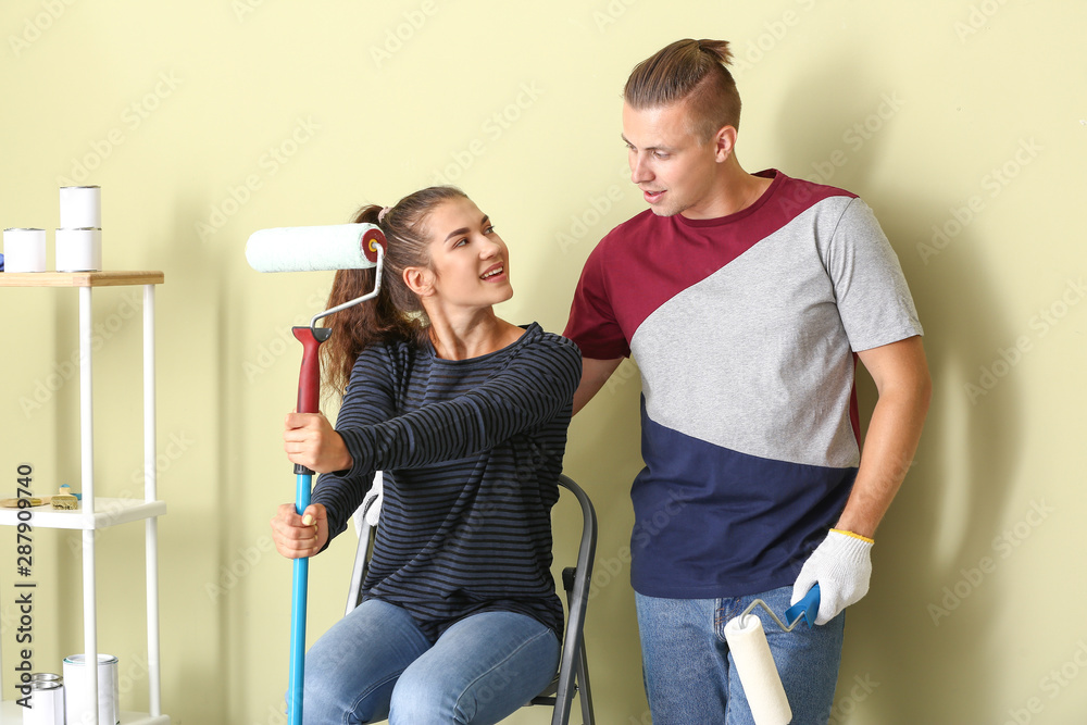 Happy young couple doing repair in their new house