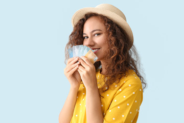 Poster - Happy African-American woman with credit cards on light color background