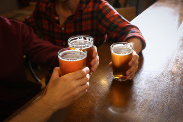 Friends drinking fresh beer in pub