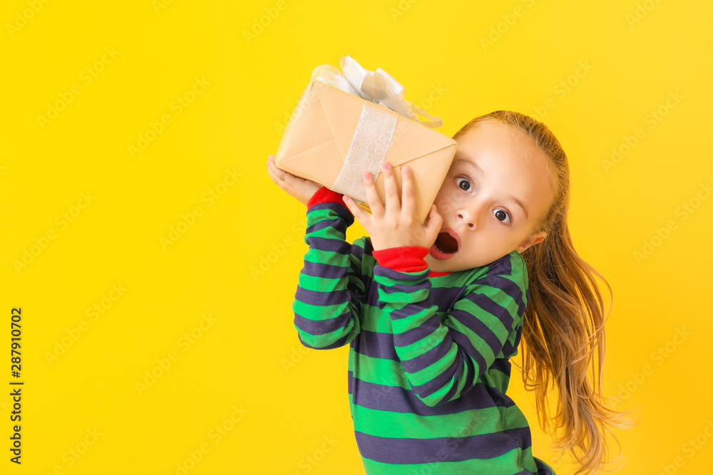 Cute little gift with Christmas gift on color background