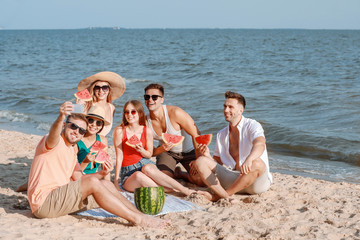 Poster - Happy friends taking selfie while eating watermelon on sea beach at resort