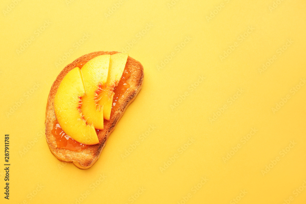 Tasty toasted bread with fruit jam on color background