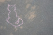 Chalk drawing of cat on asphalt. Children's creativity in the summer, the development of imagination.
