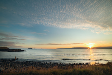 Aufkleber - Gulf coast at sunrise. Silhouettes of mountains in the dawn light. Iceland. Deserted beautiful landscape in the early morning near the water.
