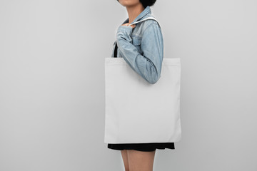 Wall Mural - young woman holding eco cotton bag isolate on white background