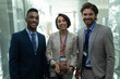 © WavebreakMediaMicro - Multi-ethnic business people standing and looking at camera in office elevator