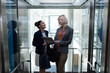 © wavebreak3 - Multi-ethnic businesswomen discussing over digital tablet in office elevator