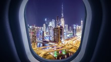 Aerial Urban Timelapse View Of Plane Aircraft Window Descending Over Dubai City Skyline Airport