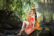 © alis - Beautiful woman in a Kinnari dress, Kinnara is an animal in the Himmapan forest.The upper body is human.The lower part is a bird with wings to fly.Lives in the Himapan forest.
