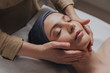 © LUMINA IMAGES - Pretty Caucasian woman enjoying face massage at beauty salon.