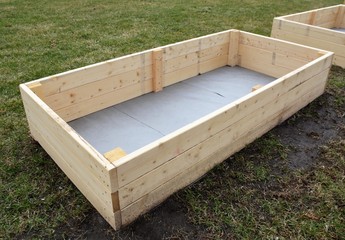 A newly constructed backyard raised garden box.