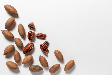 Wall Mural - Group of pecan nuts on the white background