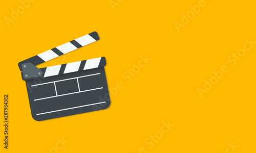 Open clapperboard isolated on yellow background Fototapete