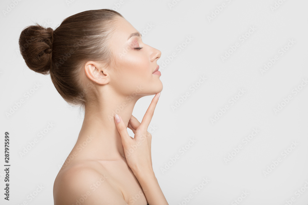 Portrait of a young woman. Bare shoulders. Hand touches face - obrazy, fototapety, plakaty 