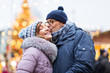 © Syda Productions - love, winter holidays and people concept - happy senior couple kissing at christmas market