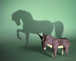 Concept of hidden potential. A paper figure of a donkey  that fills the shadow of a mustang. 3D illustration