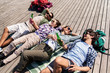 © Syda Productions - travel, tourism and people concept - friends drinking beer and cider on wooden terrace in summer