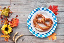 Oktoberfest, Flat Lay On Rustic Wooden Table With Pretzel And Autumn Decorations