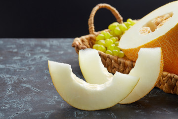 Wall Mural - Beautiful still life with a melon on a dark background. Favorite fruit in summer. Food,Fruits or healthcare concept.