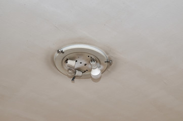 Old ceiling lamp with two bulbs while one is missing