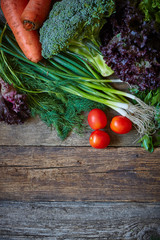 Wall Mural - Fresh vegetables and herbs on an old rough wooden surface, healthy eating concept, selective focus