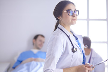 Wall Mural - Doctor checking heart beat of patient in bed with stethoscope