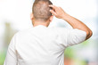 © Krakenimages.com - Middle age arab man wearig white t-shirt over isolated background Backwards thinking about doubt with hand on head