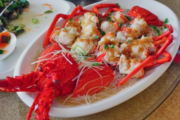 Dish of lobster in the shell in a Fujian cuisine preparation with onion and ginger in Quanzhou, China