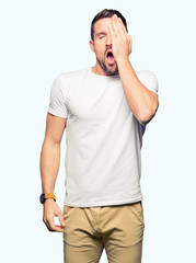 Wall Mural - Handsome man wearing casual white t-shirt Yawning tired covering half face, eye and mouth with hand. Face hurts in pain.