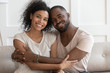© fizkes - Happy young smiling cuddling african american family portrait.