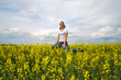 © VGV - Girl Is Jumping In A Blooming Rapeseed Field