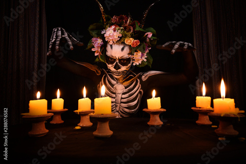 Halloween Day Of The Dead Bodypaint Portrait Decorated By Flowers On Head And Candle Lights On The Tabel In The Dark Room Buy This Stock Photo And Explore Similar Images At