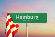 Hamburg – New York. Road Or Town Sign. Flag Of The United States. Sunset Oder Sunrise Sky. 3d Rendering