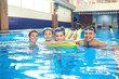 © Studio Romantic - Happy family swimming in the swimming pool.