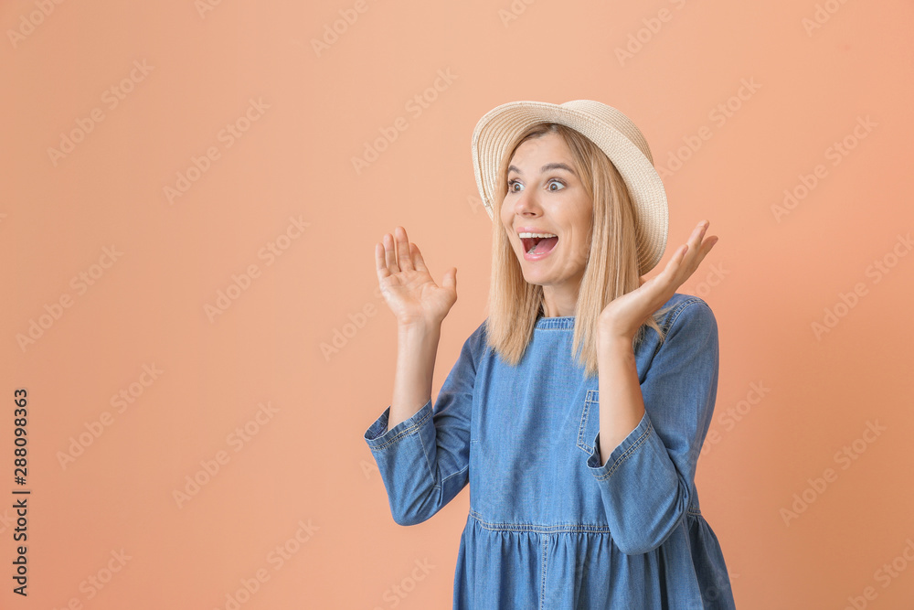 Excited beautiful woman on color background